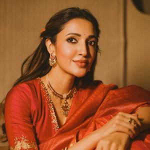 Actress Neha Shetty in Elegant Red Saree with Golden Embroidery and Statement Jewelry
