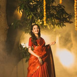 Actress Neha Shetty in Elegant Red Saree with Golden Embroidery and Statement Jewelry