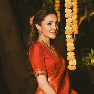 Actress Neha Shetty in Elegant Red Saree with Golden Embroidery and Statement Jewelry