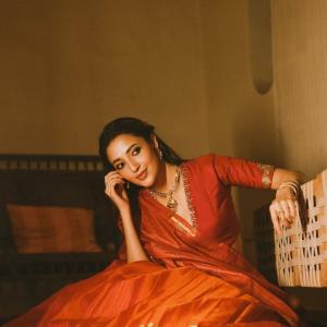 Actress Neha Shetty in Elegant Red Saree with Golden Embroidery and Statement Jewelry