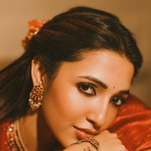 Actress Neha Shetty in Elegant Red Saree with Golden Embroidery and Statement Jewelry