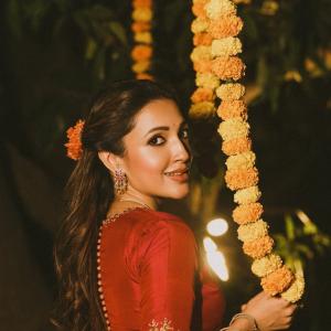 Actress Neha Shetty in Elegant Red Saree with Golden Embroidery and Statement Jewelry