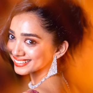 Actress Saanve Megghana in Elegant Maroon Sequin Gown with Jewelry