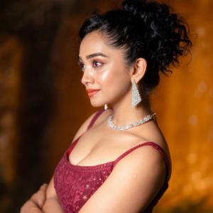 Actress Saanve Megghana in Elegant Maroon Sequin Gown with Jewelry