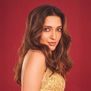 Neha Shetty Stuns in Golden Embroidered Outfit with Elegant Choker Look