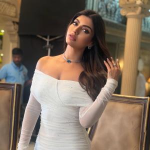 Actress Akanksha Puri in Elegant Off-Shoulder White Dress