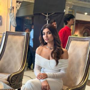 Actress Akanksha Puri in Elegant Off-Shoulder White Dress