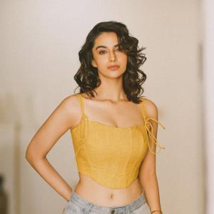 Actress Meenakshi Chaudhary in Yellow Sleeveless Top