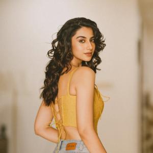 Actress Meenakshi Chaudhary in Yellow Sleeveless Top