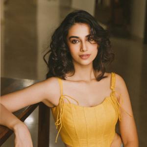Actress Meenakshi Chaudhary in Yellow Sleeveless Top