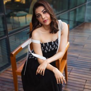 Actress Kajal Aggarwal Looks Elegant In Black Outfit With City Backdrop