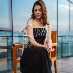 Actress Kajal Aggarwal Looks Elegant In Black Outfit With City Backdrop