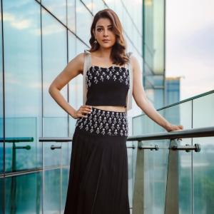 Actress Kajal Aggarwal Looks Elegant In Black Outfit With City Backdrop