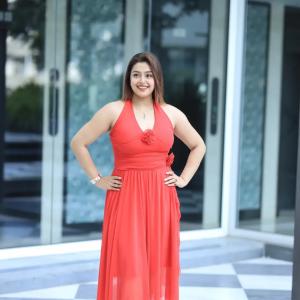 Actress Mokksha Stuns in a Vibrant Coral Red Midi Dress