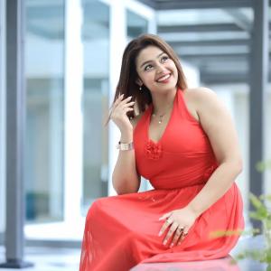 Actress Mokksha Stuns in a Vibrant Coral Red Midi Dress