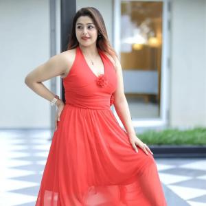 Actress Mokksha Stuns in a Vibrant Coral Red Midi Dress