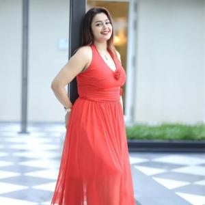 Actress Mokksha Stuns in a Vibrant Coral Red Midi Dress