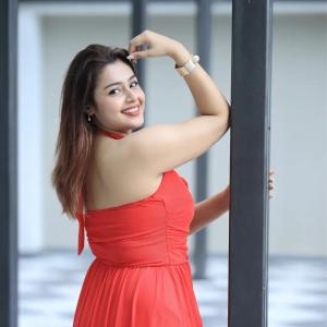 Actress Mokksha Stuns in a Vibrant Coral Red Midi Dress