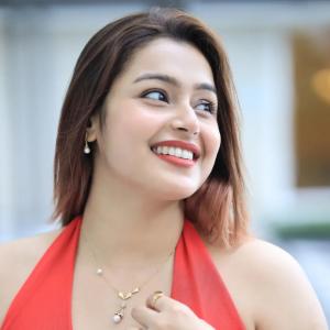 Actress Mokksha Stuns in a Vibrant Coral Red Midi Dress