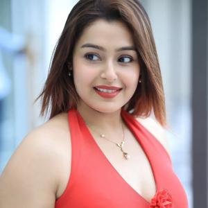 Actress Mokksha Stuns in a Vibrant Coral Red Midi Dress