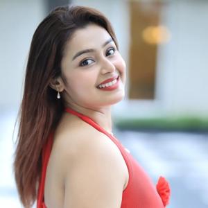 Actress Mokksha Stuns in a Vibrant Coral Red Midi Dress