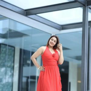Actress Mokksha Stuns in a Vibrant Coral Red Midi Dress