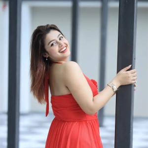 Actress Mokksha Stuns in a Vibrant Coral Red Midi Dress