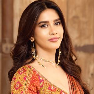 Actress Nabha Natesh Shines in a Rust Orange Printed Saree