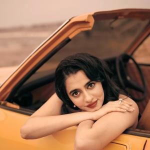 Manasa Choudhary Stuns in a Red Gown With a Retro Car