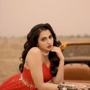 Manasa Choudhary Stuns in a Red Gown With a Retro Car
