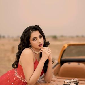 Manasa Choudhary Stuns in a Red Gown With a Retro Car