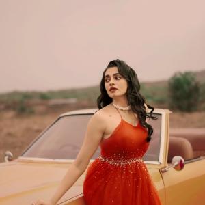 Manasa Choudhary Stuns in a Red Gown With a Retro Car