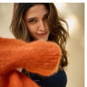 Neha Shetty Stuns in Denim Crop Top and Orange Cardigan