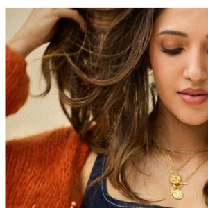 Neha Shetty Stuns in Denim Crop Top and Orange Cardigan