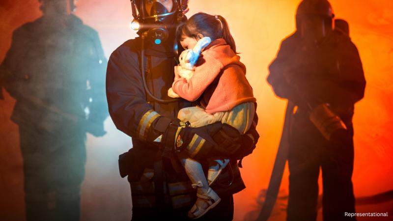 Asbury Park police officer catches child during house fire rescue operation