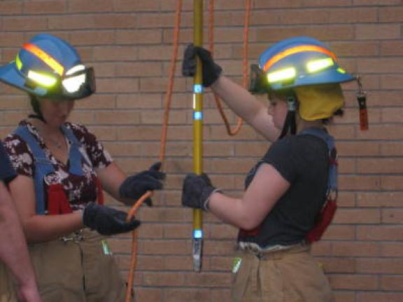Training sessions are held at 7 p.m. every Thursday. Here, two firefighters learn the proper way to move tools from the ground to a firefighter on an upper floor of a building.