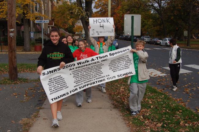 TERRY AHNER/TIMES NEWS  Students from St. John Neumann Regional School's Palmerton campus set off for the first leg of the school's annual Walkathon Friday morning armed with signs in support of their school.
