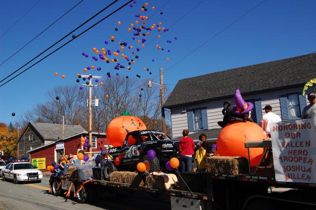 LINDA KOEHLER/TIMES NEWS Colin and Terri Dorshimer, family and friends, put together this float featuring Colin's ProArena/ProStadium modified tough truck on the tractor trailer of Martin, Tina and Zach Mallech in Honoring Our Fallen Hero Trooper…