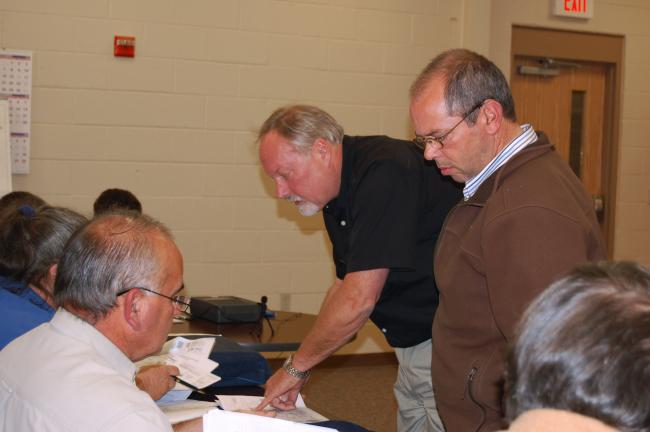 CHRIS PARKER/TIMES NEWS Phil Saunders of SIGNMedix, Lancaster, left, and Rush Township Zoning Officer William N. McMullen, right, explain plans for lighted signs for the Turkey Hill Minit Mart being built between Lincoln Avenue and Route 309 to the…