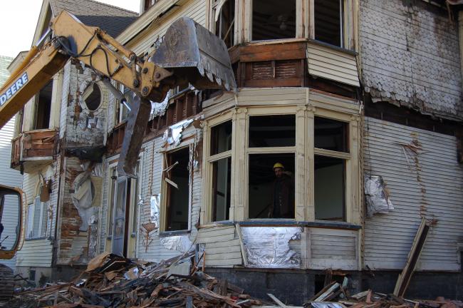 Workers from The Building Recyclers, Kutztown, dismantle the former St. Ann's convent on Bertsch Street in Lansford on Wednesday. Crews began tearing down the Queen Ann style mansion on Tuesday and expect to finish the job by Friday.
