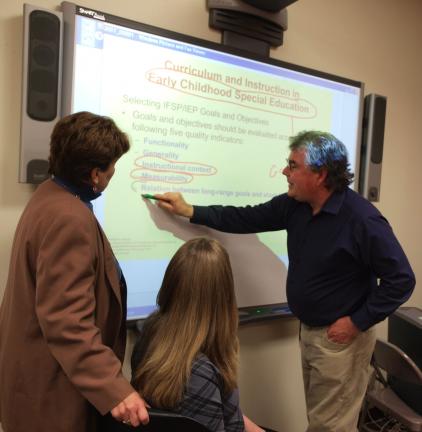 AL ZAGOFSKY/SPECIAL TO THE TIMES NEWS Jeanne Miller, left, director of Carbon Schuylkill Educational Services for LCCC and Heather Mullen, admissions for LCCC Carbon Campus, observe Joe Davis, professor of teacher education, as he circles items on a…