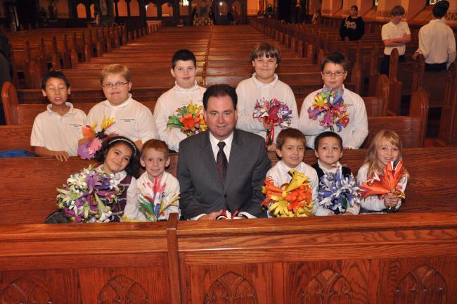 AMY ZUBEK/TIMES NEWS Speaker Keith McCall (D-Carbon) sits with students from Our Lady of the Angels Academy after an awards presentation at St. Katharine Drexel Church in Lansford. Students are, front from left, Julia Jurick, Kasey Ansbach, Rilan…
