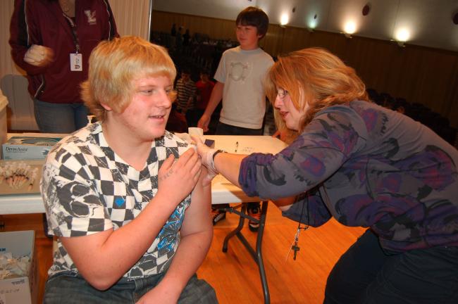 Gail Maholick/TIMES NEWS Jeremy Behler, a student at Lehighton Area Middle School and son of Gerard and Melissa Getz of Weissport receives an H1N1 inoculation from Lori German, who is a nurse at Mahoning Elementary School. Students at Lehighton Area…