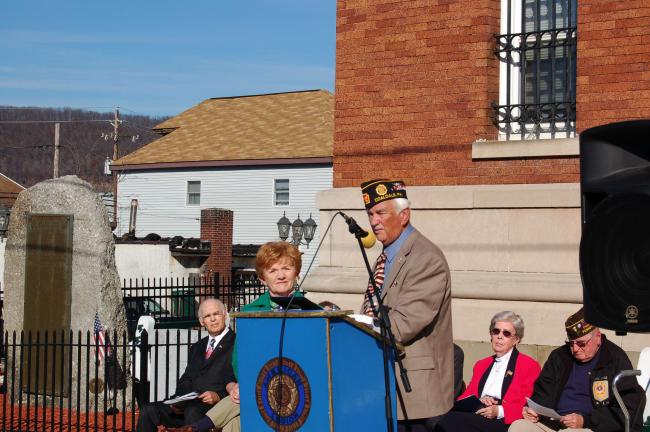 CHRIS PARKER/TIMES NEWS Mrs. Mary Edith Rhoades accepts a plaque honoring the support given by her husband, the late state Sen. James J. Rhoades, to the Coaldale World War II Memorial Committee. Committee member William Gaddes presented the plaque…