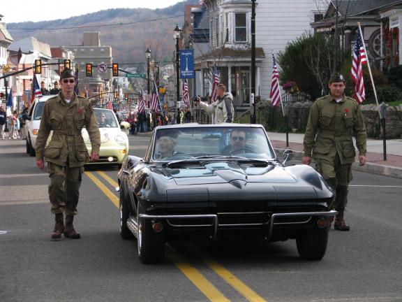 LIZ PINKEY/SPECIAL TO THE TIMES NEWS George Breunig (seated in car, left), a US Navy veteran, wore his 1943 uniform to the Tamaqua Veterans Day Parade. A World WarII veteran, Breunig served as a petty officer, gunner's mate during the War.