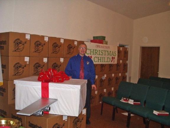 TIMES NEWS FILE PHOTO The Rev. Robert Johnson with a collection of shoe boxes from a past Operation Christmas Child drive.