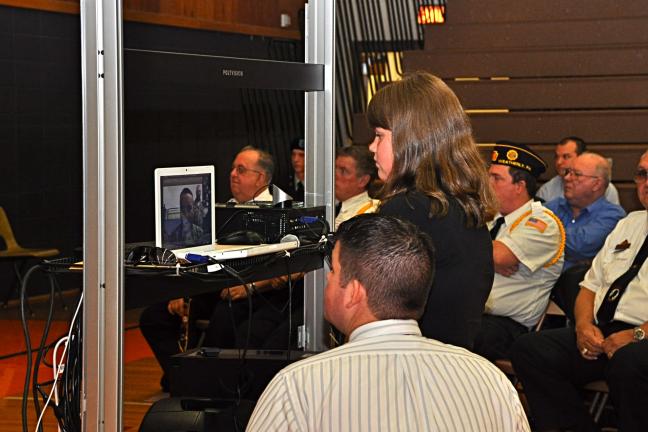 VICTOR IZZO/SPECIAL TO THE TIMES NEWS With the visiting veterans in the background, Weatherly student Samantha Hartz speaks by computer link with Engineering Equipment Operator Master Sgt. Chris Blackwell, who is currently stationed in Iraq.