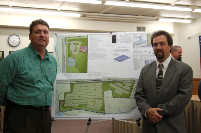 CHRIS PARKER/TIMES NEWS Green Energy Capital Partners executive director John F. Curtis III, left, and project manager David G. Lear of Lehigh Engineering Associates, flank plans for a 134-acre solar park to be built in Nesquehoning.