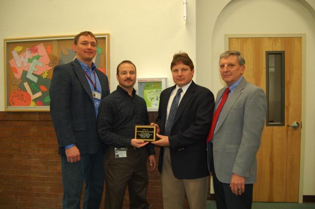 Gail Maholick/TIMES NEWS An automated external defibrillator was donated to Behavioral Health Associates in Packerton by Berger Construction, in honor of Leonard Ogozalek's dedication to students. From left are, J. Christopher West, superintendent…