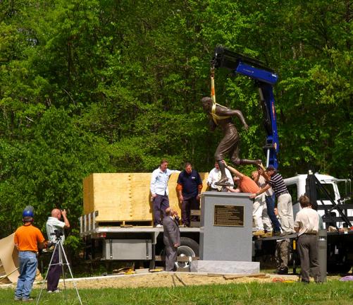FILE PHOTO The bronze statue of Jim Thorpe is lowered onto a granite pedestal at the Jim Thorpe Memorial in the Borough of Jim Thorpe several years ago. A lawsuit threatens to remove Thorpe's remains to his family home in Oklahoma.